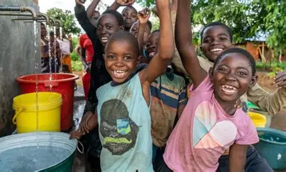 Smiling children with clean water